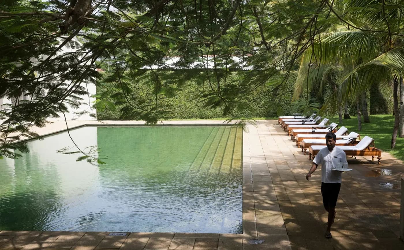 A long green pool in a walled garden inside Galle Fort