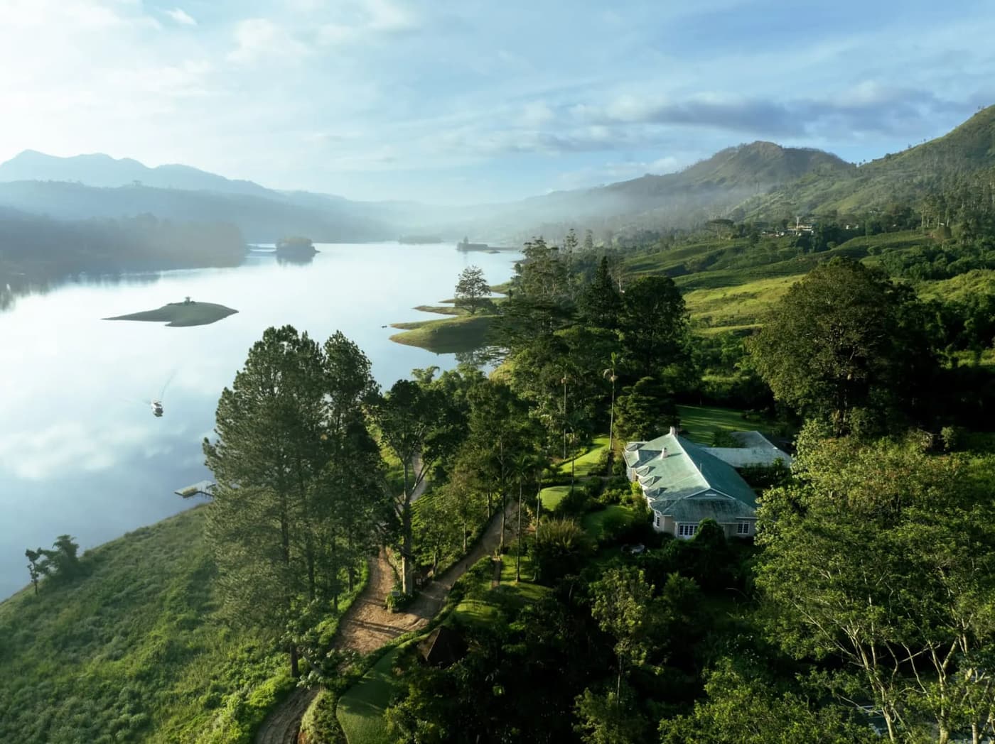 A tea planter's bungalow above a lake and misty hills